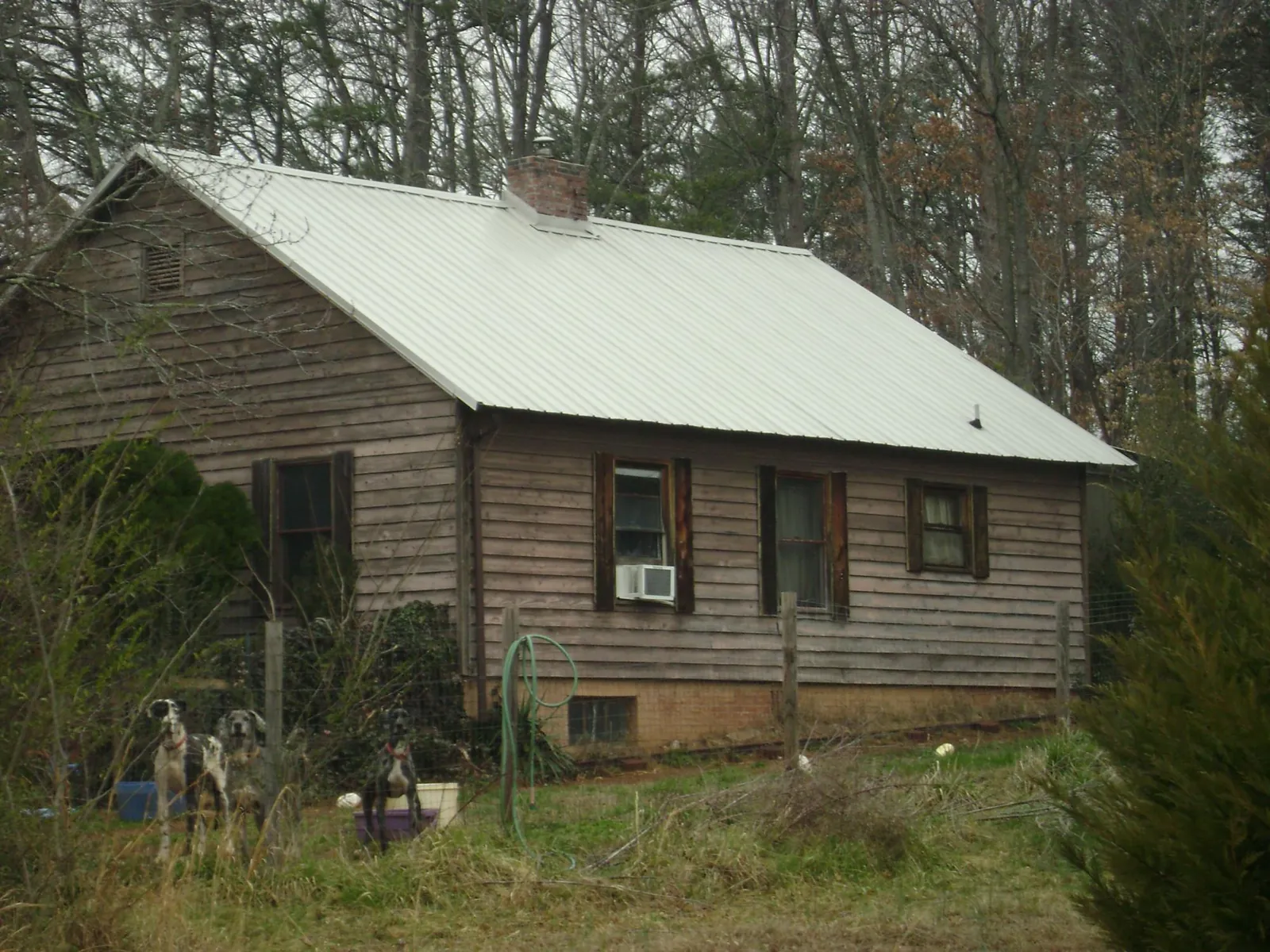 White metal roof on an old wood sided farmhouse, from a Metal Roof Installation job in Oceanport